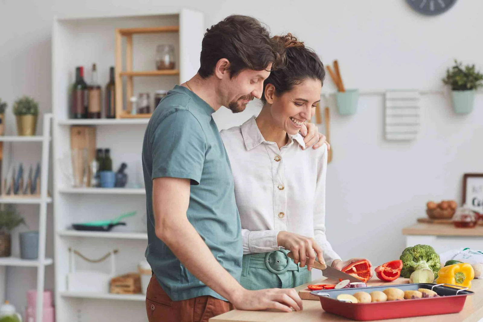 man and woman chop vegetables